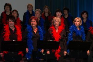 Beim Kriminaltango legen sich die Sängerinnen der STIMMGABEL bunte Federboas um